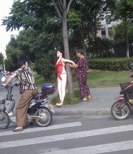 [IMG: Inflatable woman tied to tree]