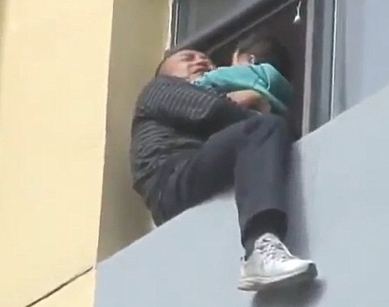 [IMG: Man and child on window ledge, part of a photo series shown in Chinese media]