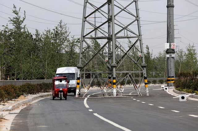 [IMG: Pylon in road]